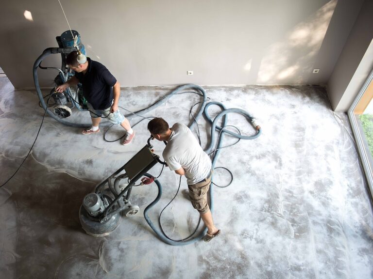 Grinding the concrete to prepare the surface before applying polyaspartic flooring